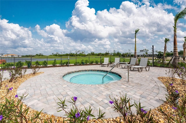 view of pool with a patio and a hot tub