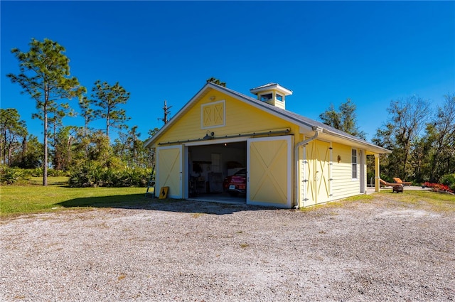 exterior space with a garage and an outdoor structure