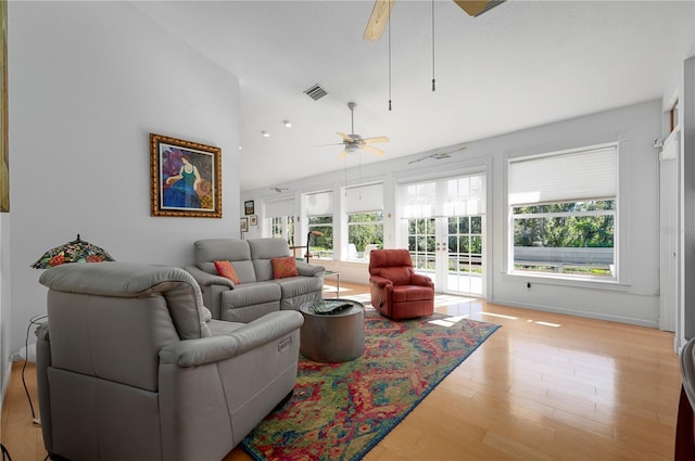 living room featuring plenty of natural light, ceiling fan, french doors, and light hardwood / wood-style flooring