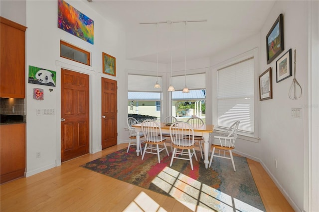 dining space with light wood-type flooring