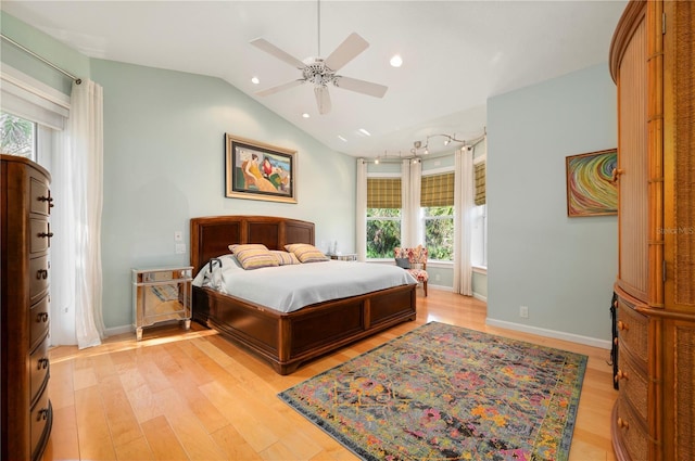 bedroom featuring ceiling fan, light hardwood / wood-style floors, and lofted ceiling