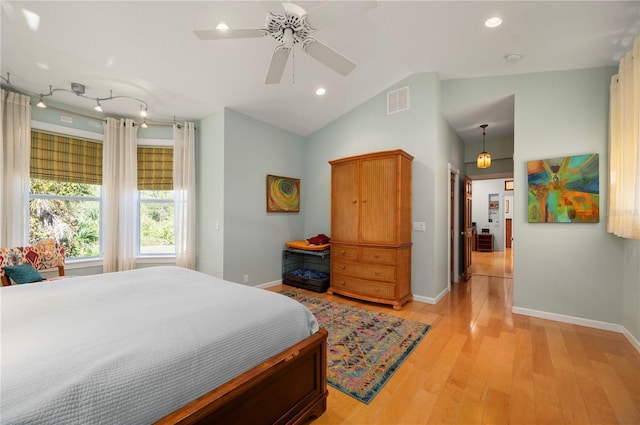 bedroom featuring light hardwood / wood-style floors, ceiling fan, and lofted ceiling