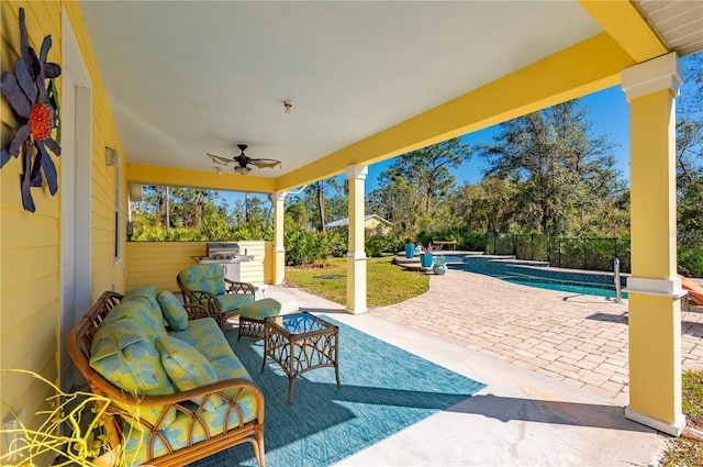 view of patio / terrace featuring outdoor lounge area, a fenced in pool, and ceiling fan