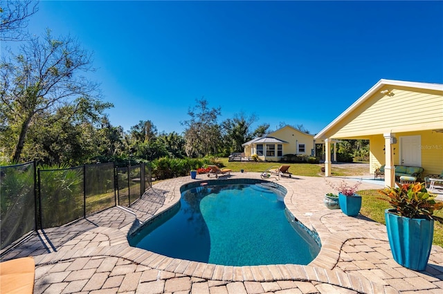 view of pool with a lawn and a patio area