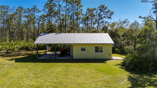 exterior space featuring a yard and a carport