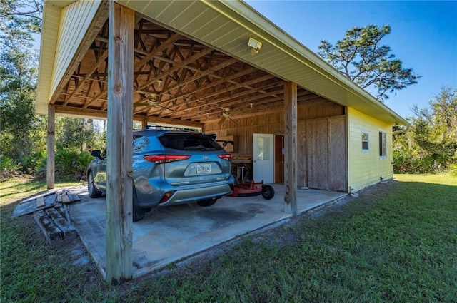 view of car parking featuring a yard and a carport