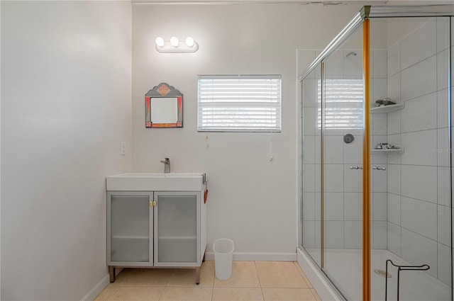 bathroom with tile patterned floors, sink, and walk in shower