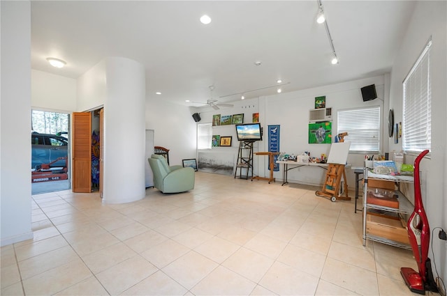 living room featuring ceiling fan, light tile patterned flooring, and track lighting