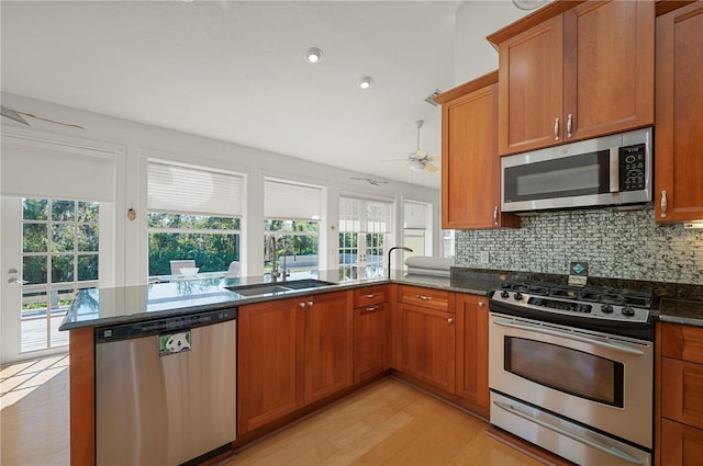 kitchen featuring a healthy amount of sunlight, sink, stainless steel appliances, and light hardwood / wood-style flooring