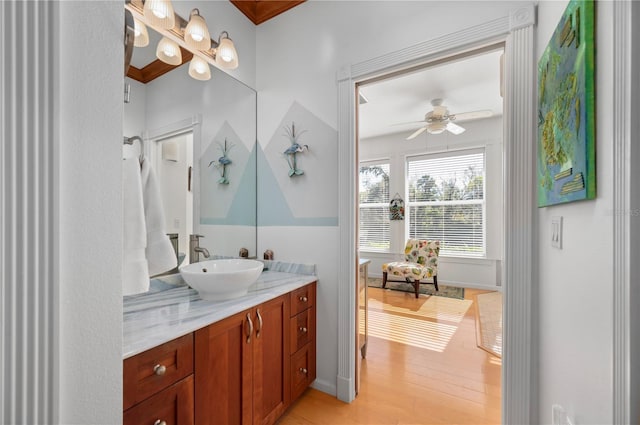 bathroom featuring vanity, crown molding, ceiling fan, and hardwood / wood-style flooring