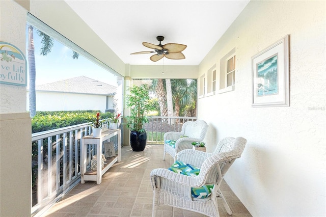 sunroom / solarium featuring ceiling fan