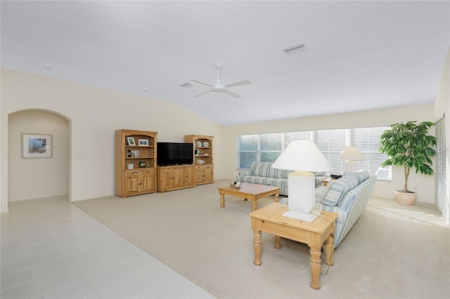 carpeted living room with ceiling fan and lofted ceiling