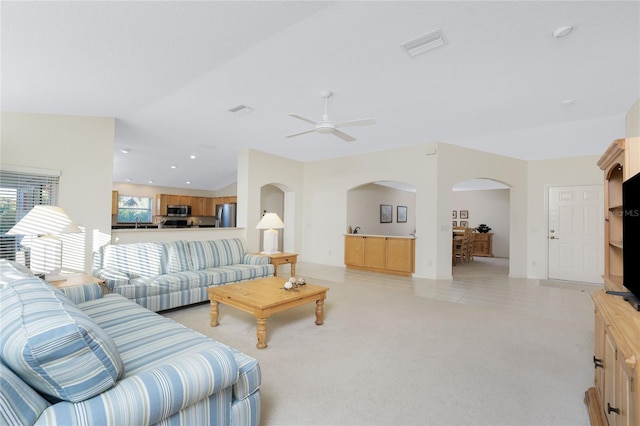 carpeted living room featuring ceiling fan