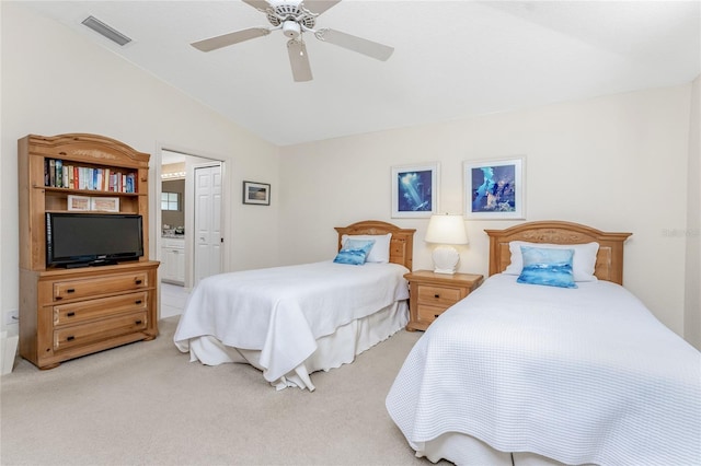 carpeted bedroom featuring ceiling fan, lofted ceiling, and ensuite bathroom