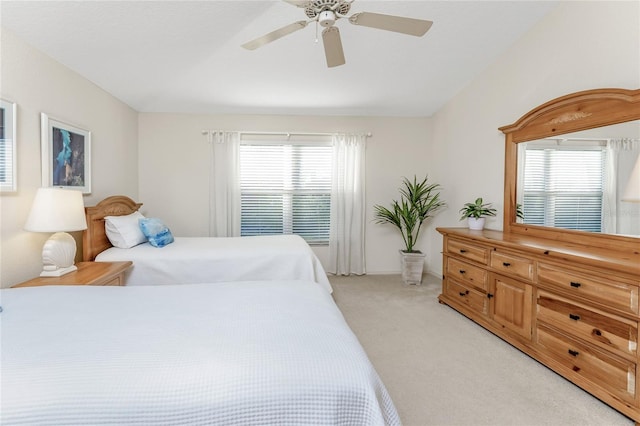 carpeted bedroom with ceiling fan and multiple windows