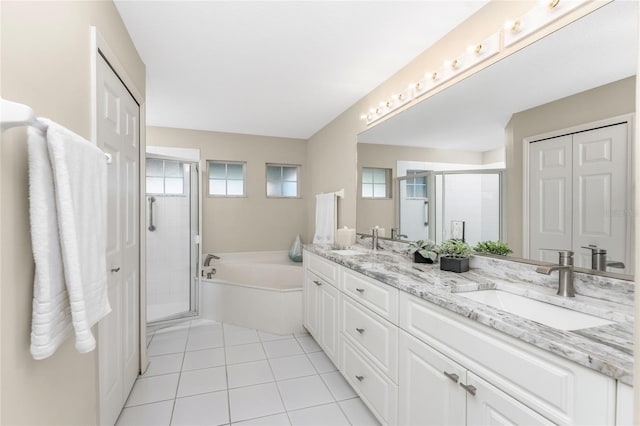 bathroom with tile patterned flooring, vanity, and plus walk in shower