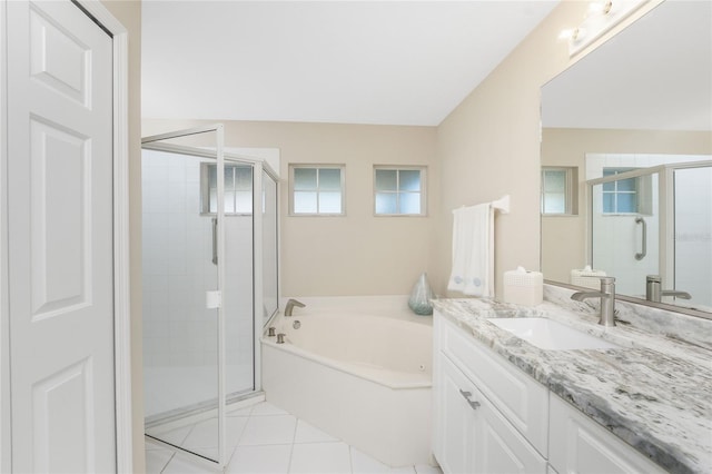 bathroom with separate shower and tub, a wealth of natural light, tile patterned flooring, and vanity