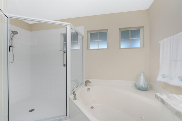 bathroom featuring shower with separate bathtub