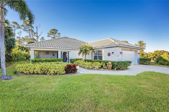 mediterranean / spanish-style home with a garage and a front yard