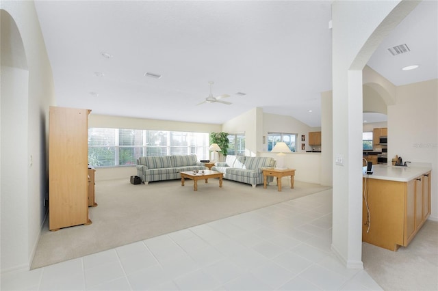 carpeted living room featuring ceiling fan and lofted ceiling