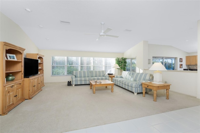 living room featuring ceiling fan, light colored carpet, a healthy amount of sunlight, and lofted ceiling