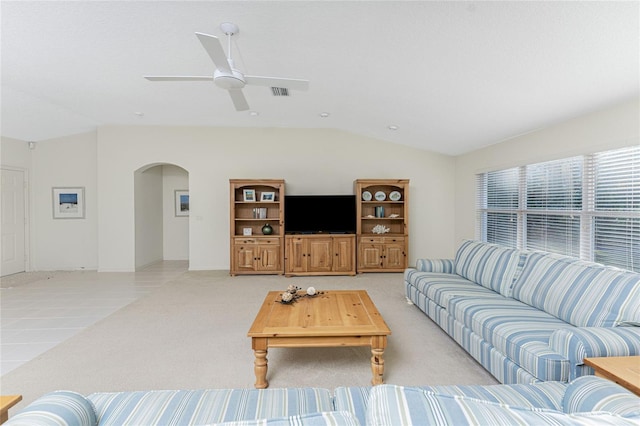 carpeted living room with ceiling fan and lofted ceiling