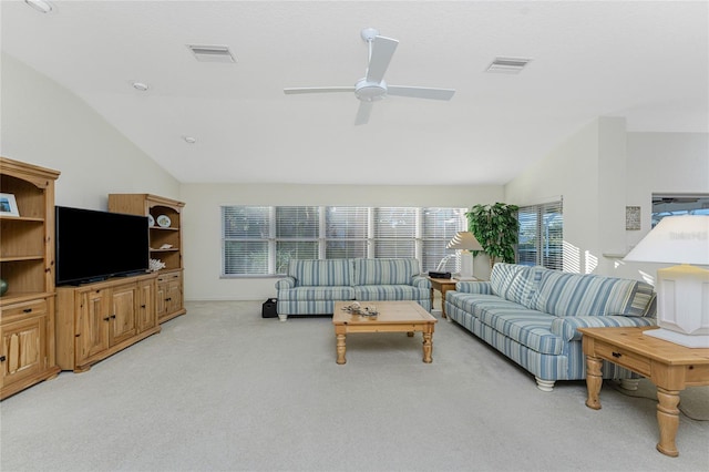 carpeted living room featuring ceiling fan and vaulted ceiling