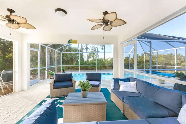 view of patio / terrace featuring glass enclosure, ceiling fan, and an outdoor hangout area