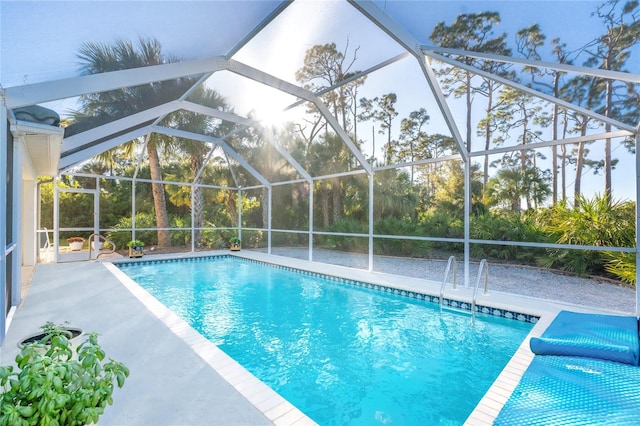 view of swimming pool with a patio area and a lanai