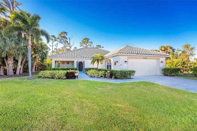 mediterranean / spanish-style home with a front yard and a garage