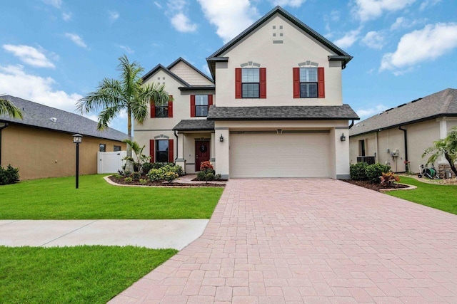 front of property with a garage and a front lawn