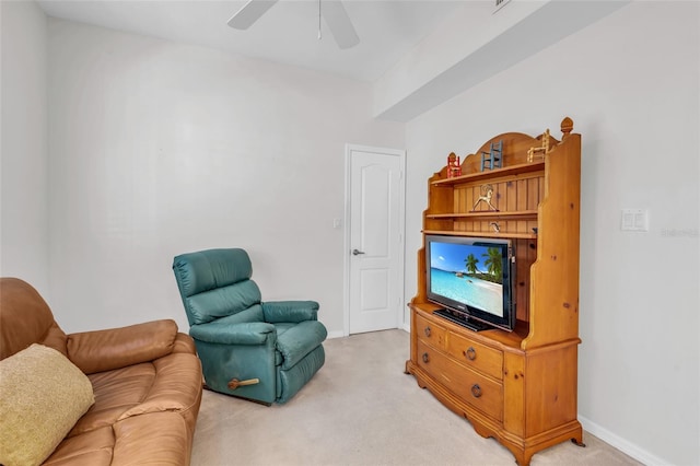 carpeted living room with ceiling fan