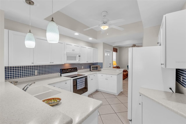 kitchen with pendant lighting, white appliances, kitchen peninsula, ceiling fan, and white cabinetry