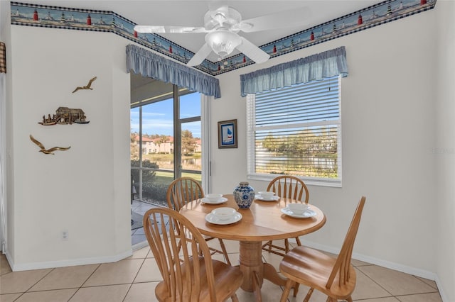 dining space with ceiling fan, plenty of natural light, and light tile patterned flooring