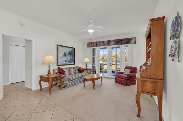 living room featuring french doors, light tile patterned floors, and ceiling fan