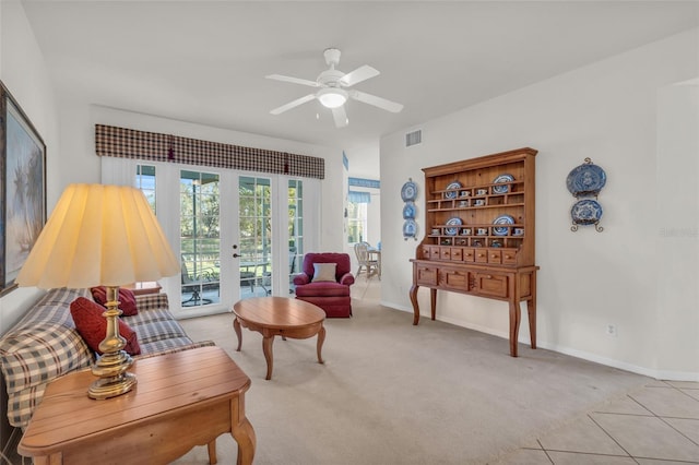 carpeted living room featuring ceiling fan and french doors