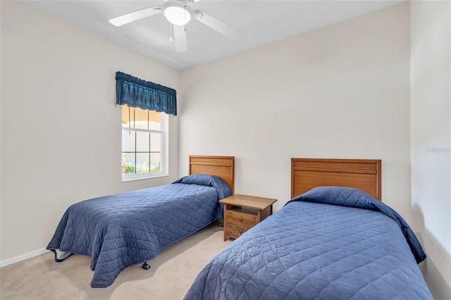 bedroom with ceiling fan and light carpet