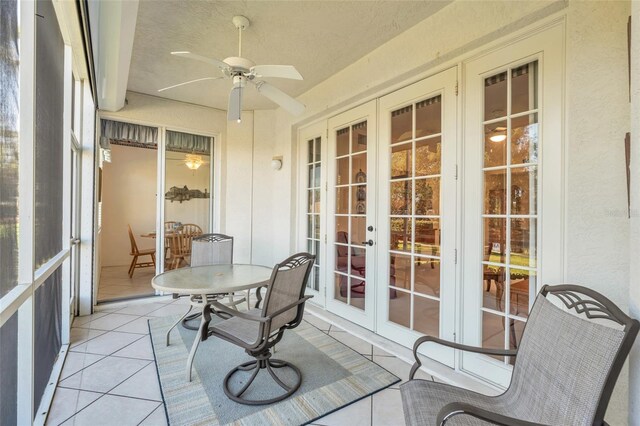 sunroom featuring ceiling fan and french doors