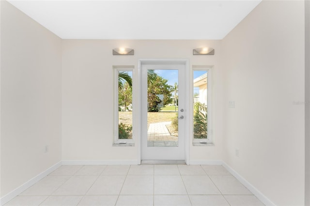 doorway to outside featuring light tile patterned flooring