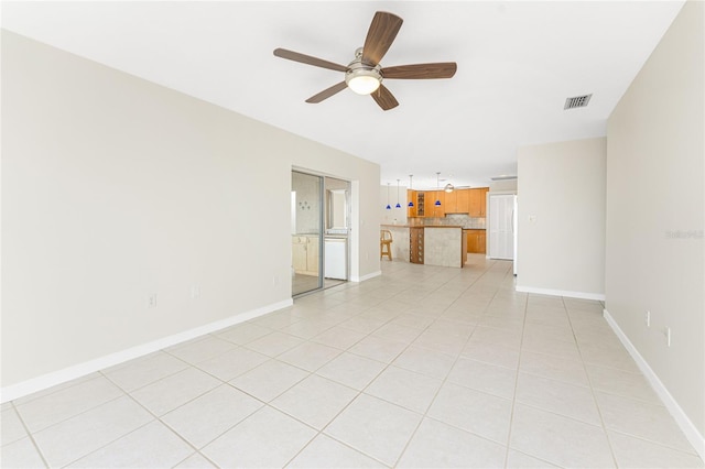 unfurnished living room with ceiling fan, visible vents, baseboards, and light tile patterned flooring