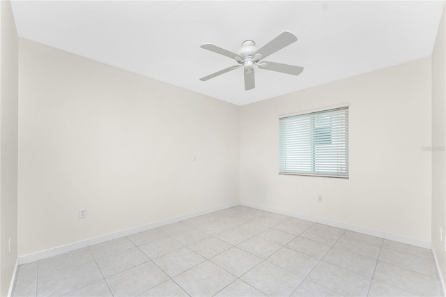 spare room with ceiling fan and baseboards