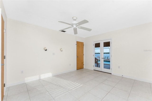 spare room with ceiling fan, light tile patterned floors, and french doors