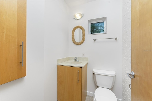 half bathroom with vanity and toilet