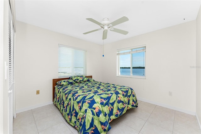 bedroom with ceiling fan and light tile patterned flooring