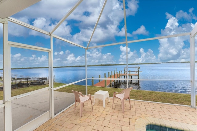 view of patio with a boat dock, a lanai, a water view, and boat lift