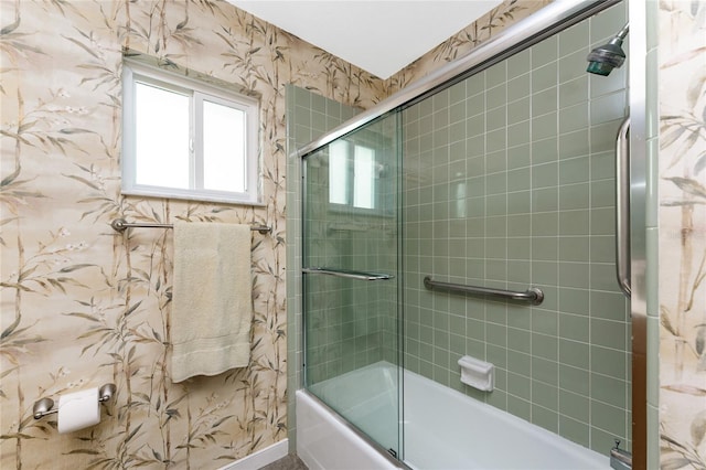 bathroom featuring enclosed tub / shower combo and wallpapered walls