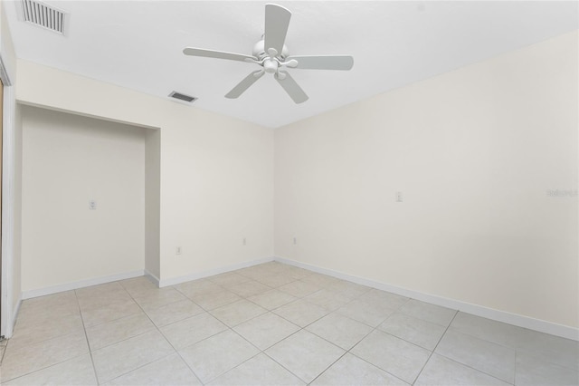 unfurnished room with baseboards, visible vents, and ceiling fan