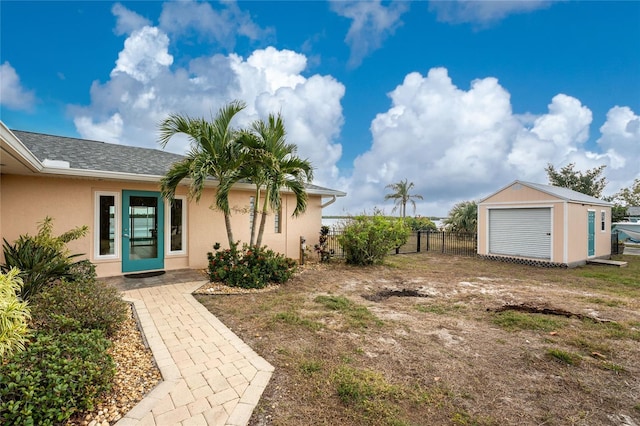 view of yard with an outdoor structure, a storage unit, and fence