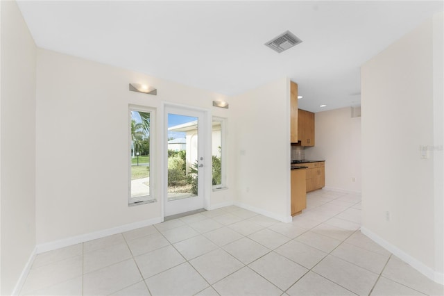 interior space featuring light tile patterned floors, visible vents, recessed lighting, and baseboards