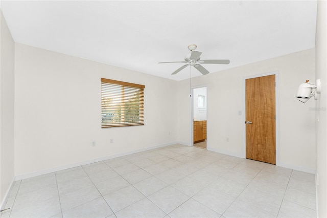 spare room with baseboards and ceiling fan